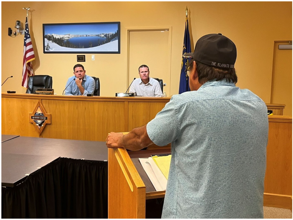 Klamath Tribes Chairman Clayton Dumont addresses Klamath County Commissioners Derrick DeGroot (left) and Dave Henslee during a public hearing on Hagelstein Park public access and the need for environmental safeguards and improvements.