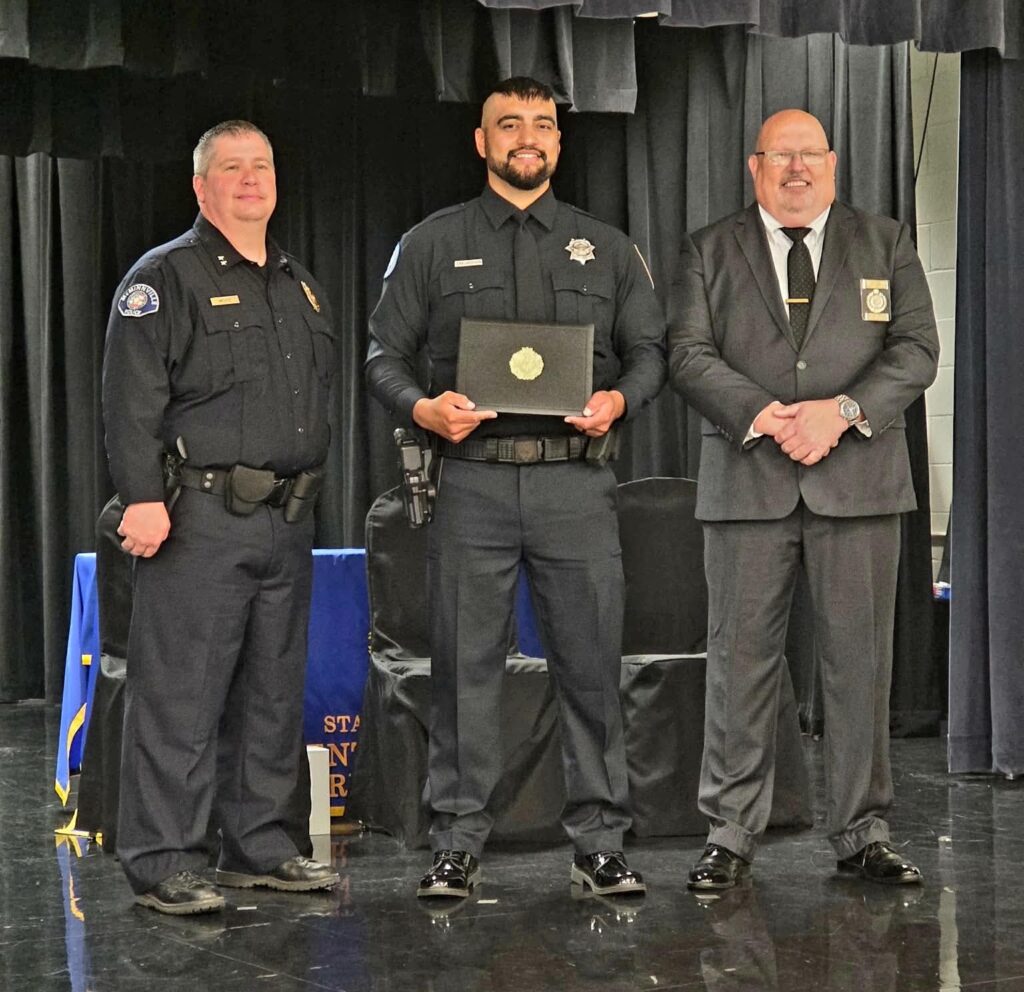 Klamath Tribes Police Officer Zak Jackson stands with two representatives at his DPSST Basic Police Class 465 graduation in Salem.
